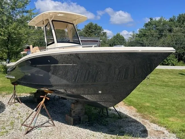 The Image of 2025 Scout 240 XSF boat on stands, displayed outdoors on a sunny day. - 0