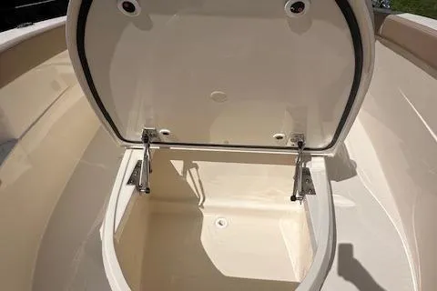 Slide: The Image of Open storage compartment on 2025 Scout 240 XSF boat, showcasing interior space. - 13