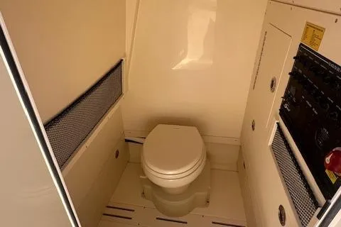 Slide: The Image of 2025 Scout 240 XSF boat interior with toilet and control panel. - 14