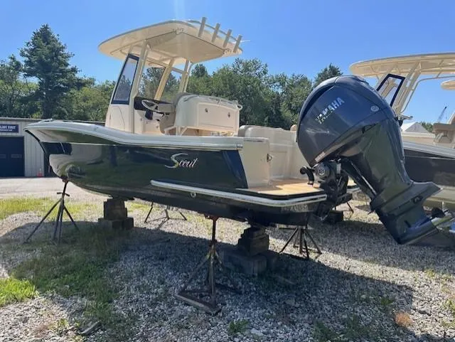 Slide: The Image of 2025 Scout 240 XSF boat with Yamaha outboard engine on display outdoors. - 2