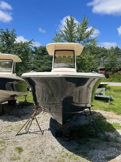 Slide: The Image of 2025 Scout 240 XSF boat on display outdoors, sunny day, blue sky. - 4