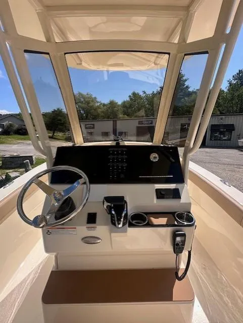 Slide: The Image of 2025 Scout 240 XSF boat helm with steering wheel and control panel. - 9