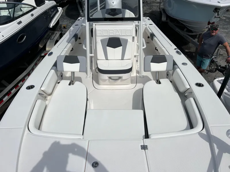 Slide: The Image of 2024 Robalo 246 Sky Deck boat interior with seating and console. - 10