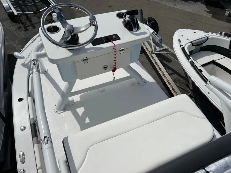 Slide: The Image of 2024 Robalo 246 Sky Deck boat helm station with steering wheel and controls. - 12