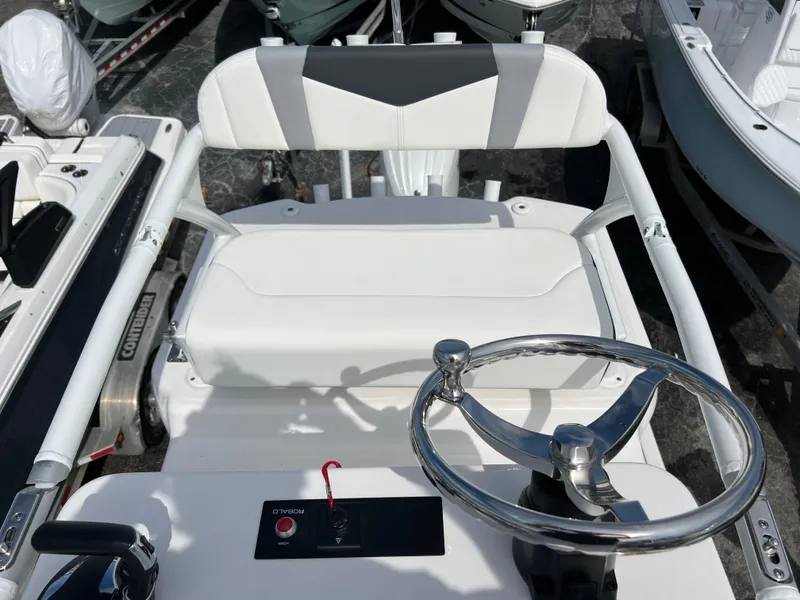 Slide: The Image of 2024 Robalo 246 Sky Deck boat helm with steering wheel and control panel. - 13