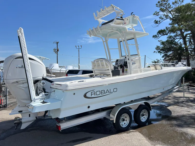 Slide: The Image of 2024 Robalo 246 Sky Deck boat on a trailer, side view. - 2