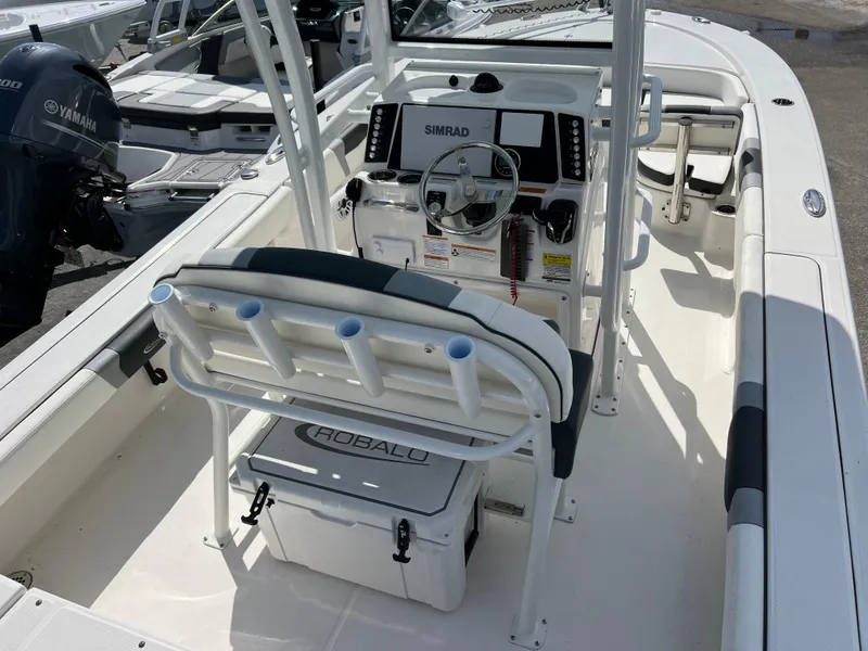 Slide: The Image of 2024 Robalo 246 Sky Deck boat interior with helm station and seating. - 6