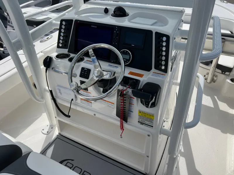 Slide: The Image of 2024 Robalo 246 Sky Deck boat helm with modern controls and navigation system. - 7