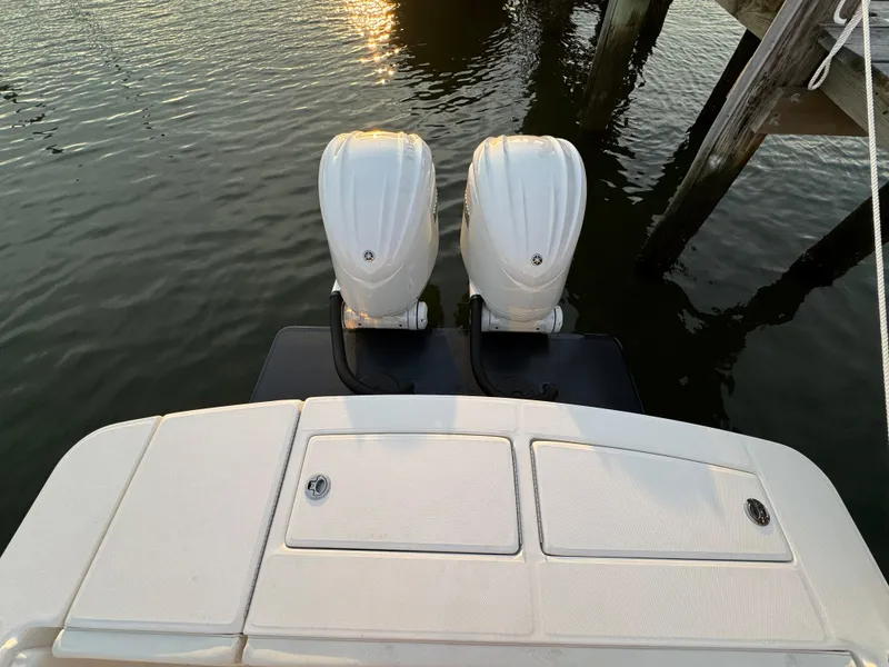 Slide: The Image of 2024 Regulator 28 boat with dual outboard engines at dock. - 11