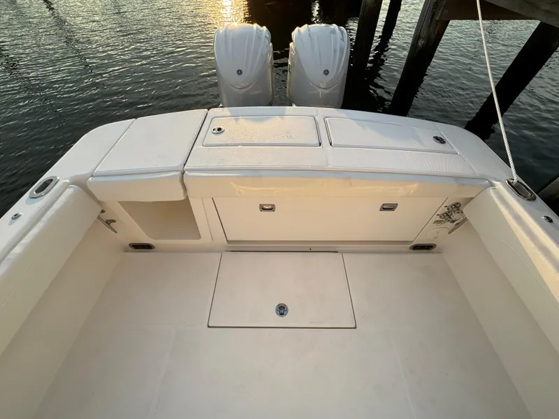 Slide: The Image of 2024 Regulator 28 boat deck with dual engines at sunset. - 13