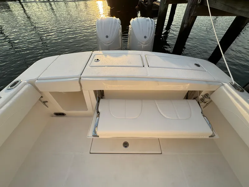 Slide: The Image of 2024 Regulator 28 boat with dual engines and seating, docked at sunset. - 14