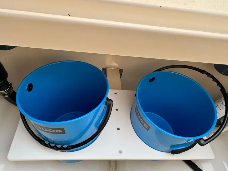 Slide: The Image of Two blue buckets on a Regulator 28 boat, 2024 model. - 15