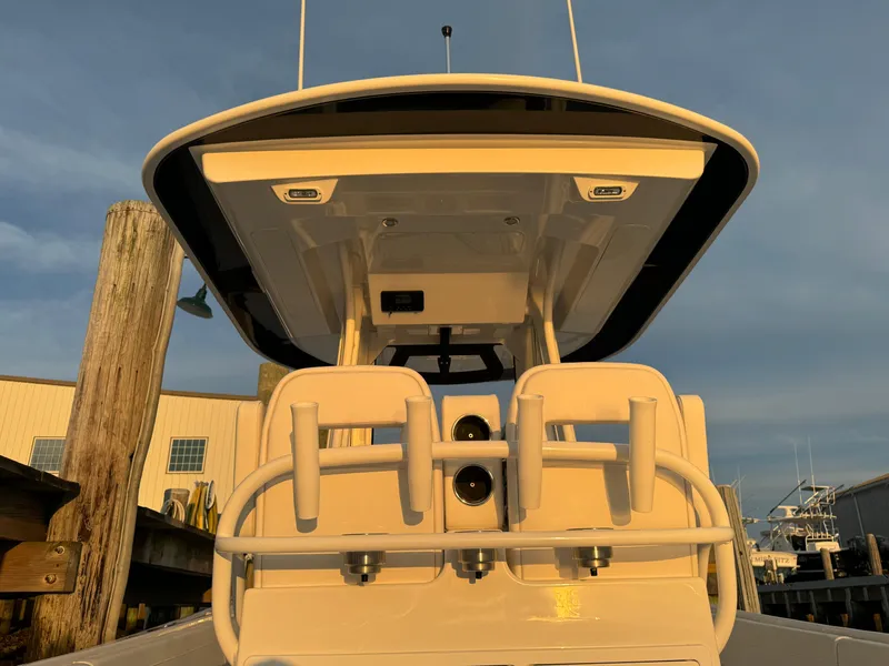 Slide: The Image of 2024 Regulator 28 boat, rear view at dock, showcasing seating and structure. - 17