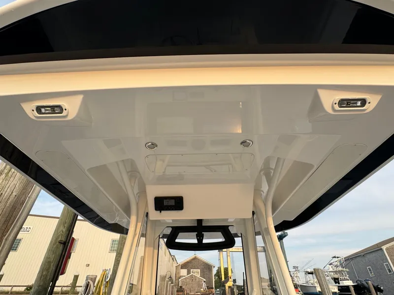 Slide: The Image of 2024 Regulator 28 boat's T-top with integrated lighting and sturdy support poles. - 19