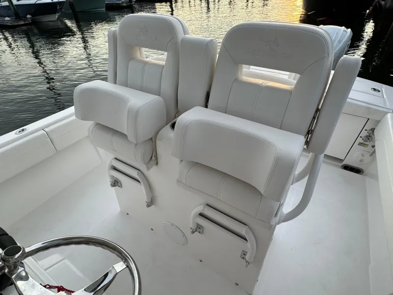 Slide: The Image of 2024 Regulator 28 boat with white cushioned seats at sunset. - 22