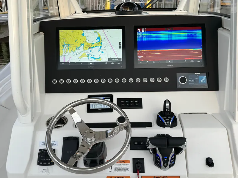 Slide: The Image of 2024 Regulator 28 boat dashboard with navigation and sonar displays. - 25