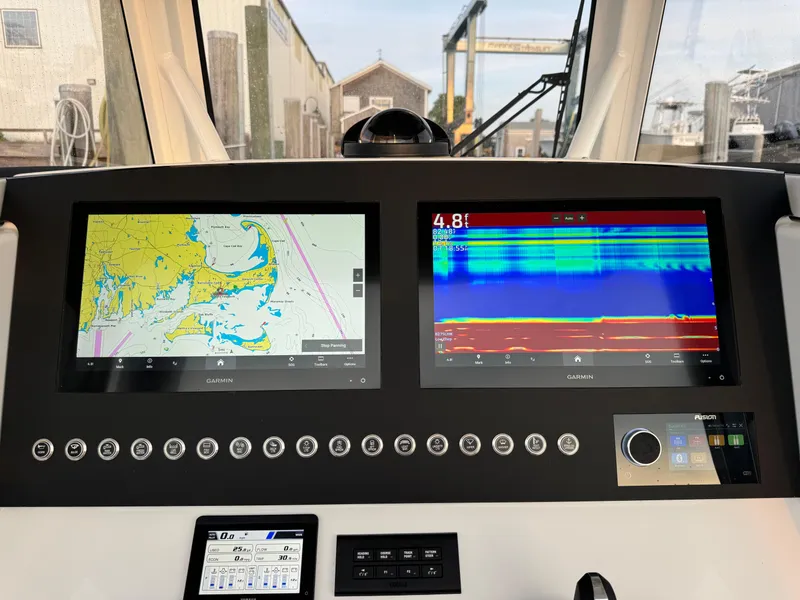 Slide: The Image of 2024 Regulator 28 boat dashboard with navigation and sonar displays. - 26