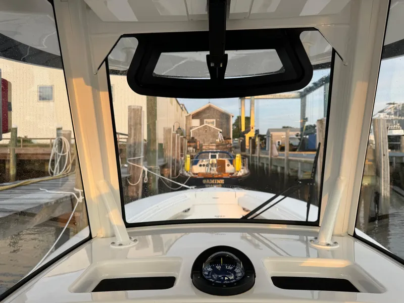 Slide: The Image of 2024 Regulator 28 boat dashboard view at marina dock. - 31