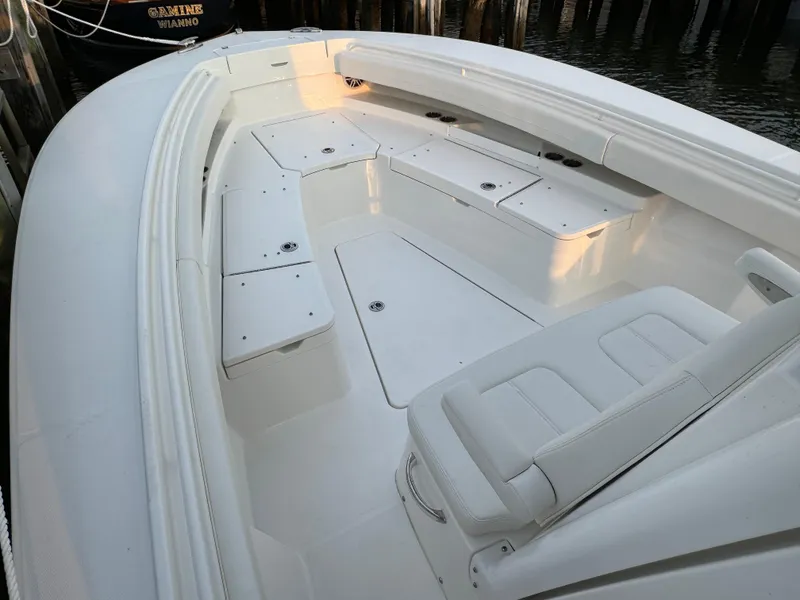 Slide: The Image of 2024 Regulator 28 boat interior with white seating and storage compartments. - 32