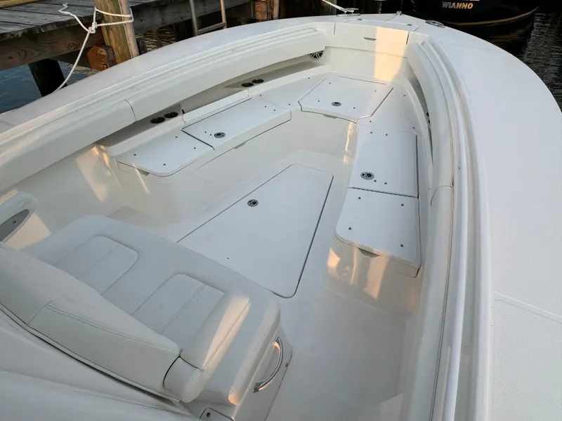 Slide: The Image of 2024 Regulator 28 boat interior with white seating and storage compartments. - 33