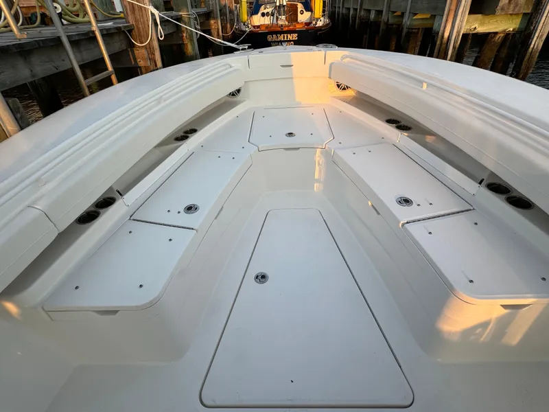 Slide: The Image of 2024 Regulator 28 boat deck with storage compartments at dock. - 34