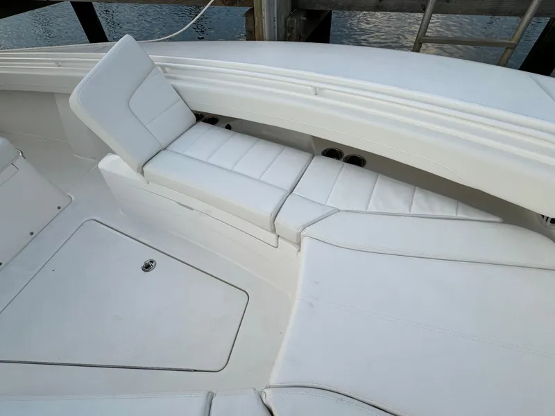 Slide: The Image of 2024 Regulator 28 boat with white cushioned seating and storage compartment. - 38