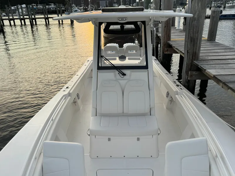 Slide: The Image of 2024 Regulator 28 boat docked at sunset, showcasing sleek design and spacious seating. - 40