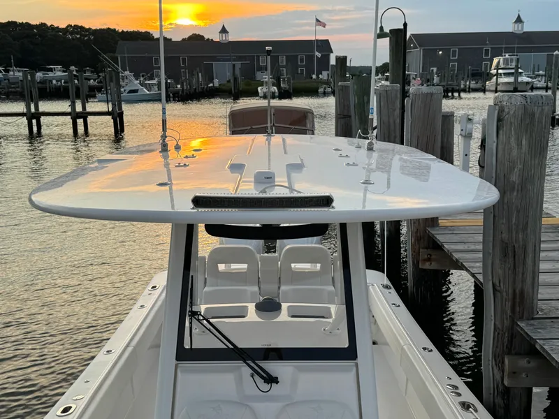 Slide: The Image of 2024 Regulator 28 boat docked at sunset, marina background. - 41