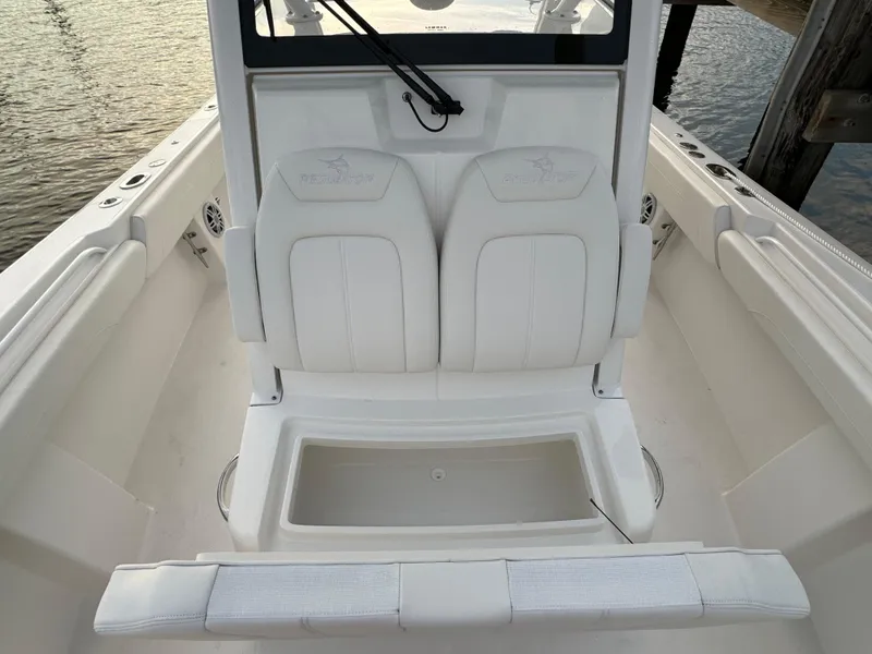 Slide: The Image of 2024 Regulator 28 boat interior with white seating and storage compartment. - 42
