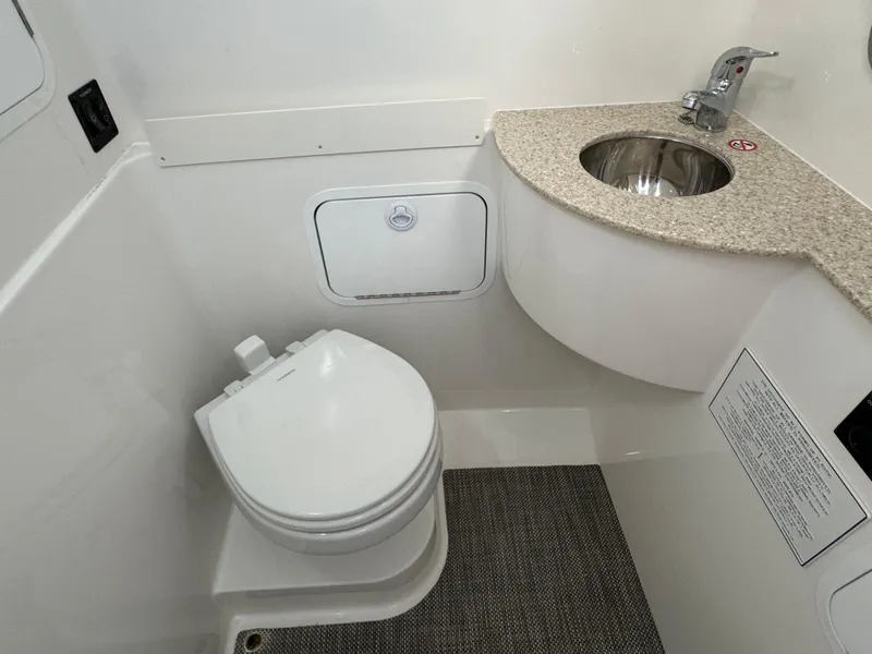 Slide: The Image of 2024 Regulator 28 boat bathroom with toilet and sink. - 45