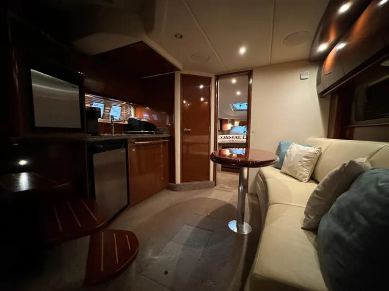 Slide: The Image of Interior of 2008 Sea Ray 38 Sundancer yacht with kitchen and seating area. - 16