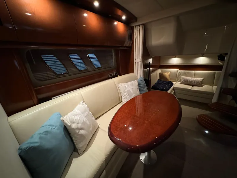 Slide: The Image of Luxurious interior of 2008 Sea Ray 38 Sundancer yacht with plush seating and wooden table. - 17