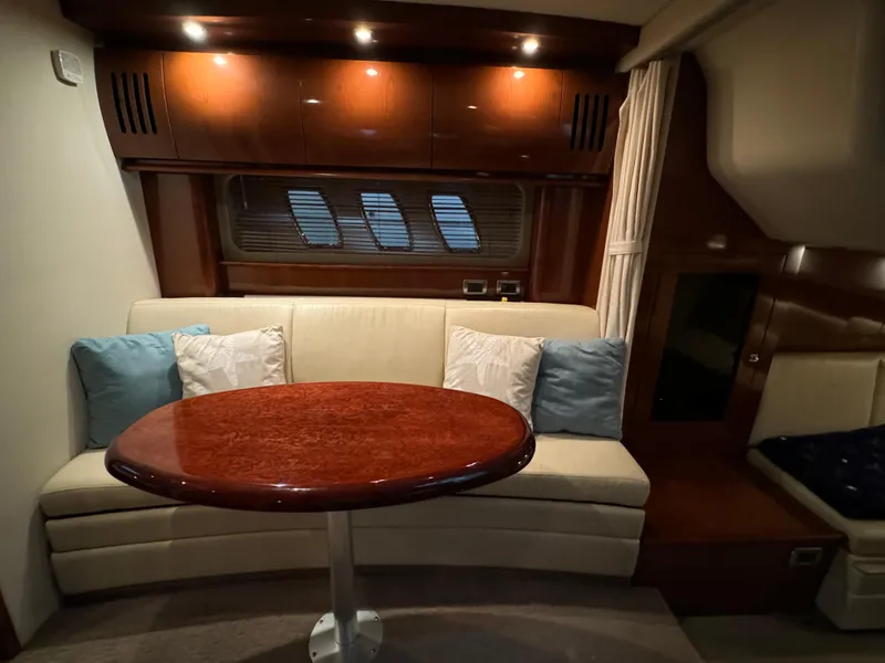 Slide: The Image of Interior of 2008 Sea Ray 38 Sundancer with sofa, table, and cushions. - 19