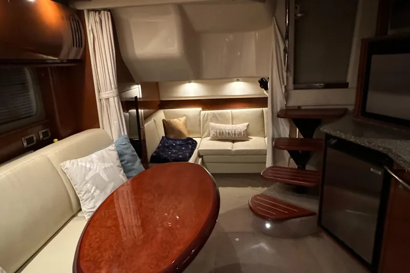 Slide: The Image of Luxurious interior of 2008 Sea Ray 38 Sundancer with cozy seating and elegant wooden table. - 21