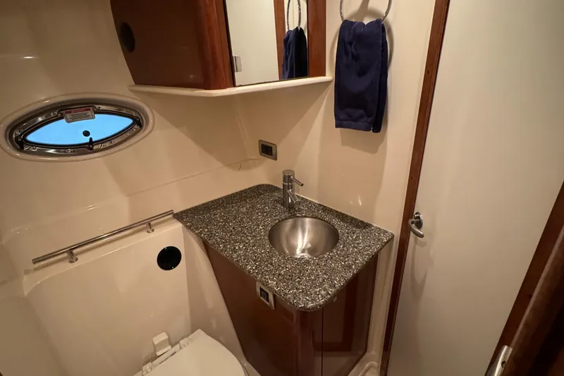 Slide: The Image of 2008 Sea Ray 38 Sundancer bathroom with granite countertop and stainless steel sink. - 25