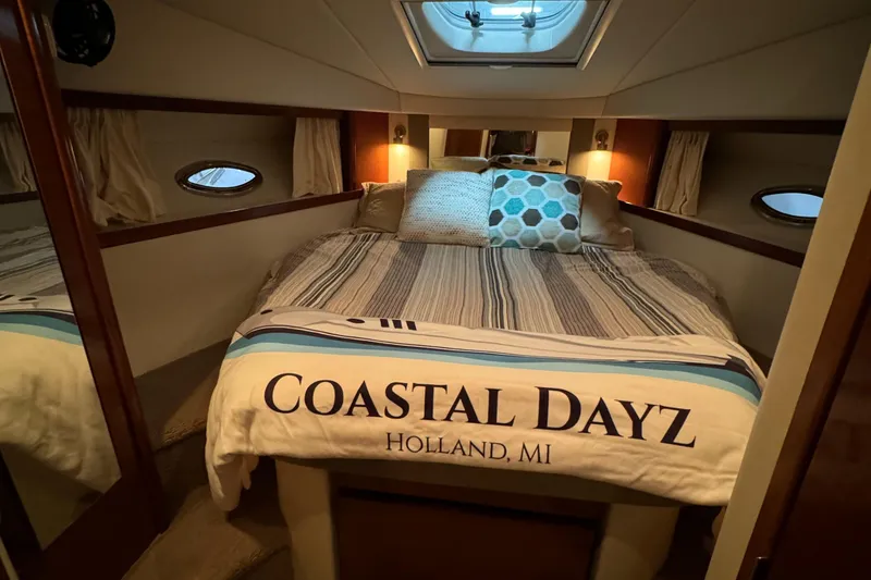 Slide: The Image of 2008 Sea Ray 38 Sundancer cabin with cozy bed and Coastal Dayz blanket. - 27