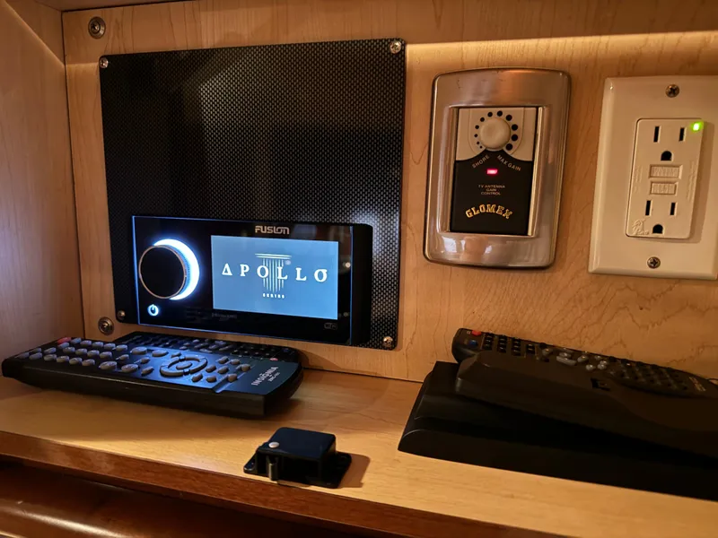 Slide: The Image of Control panel and remotes in 2008 Sea Ray 38 Sundancer yacht cabin. - 28