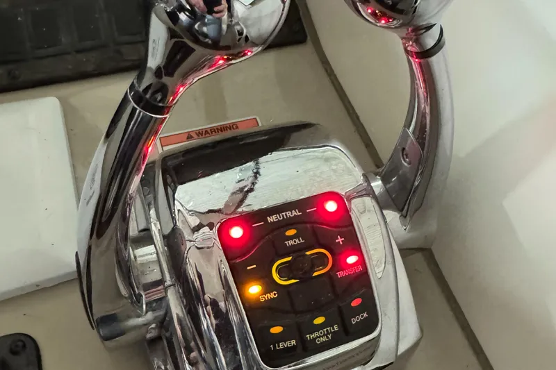 Slide: The Image of Close-up of 2008 Sea Ray 38 Sundancer throttle controls with illuminated buttons. - 29