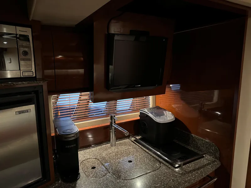 Slide: The Image of Galley kitchen in 2008 Sea Ray 38 Sundancer yacht with appliances and TV. - 31