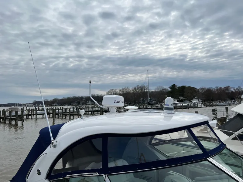 Slide: The Image of 2008 Sea Ray 38 Sundancer docked at a marina under a cloudy sky. - 4