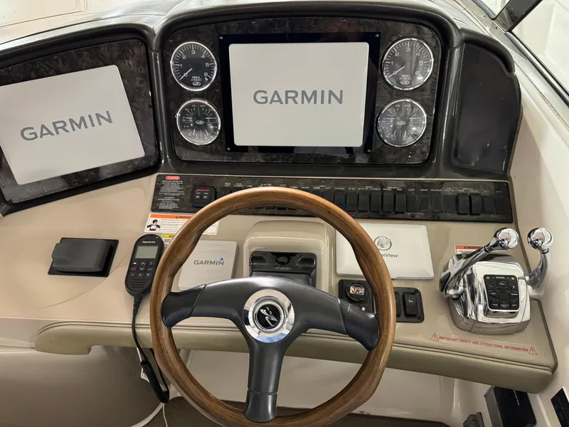 Slide: The Image of 2008 Sea Ray 38 Sundancer helm with Garmin navigation system and wood steering wheel. - 5