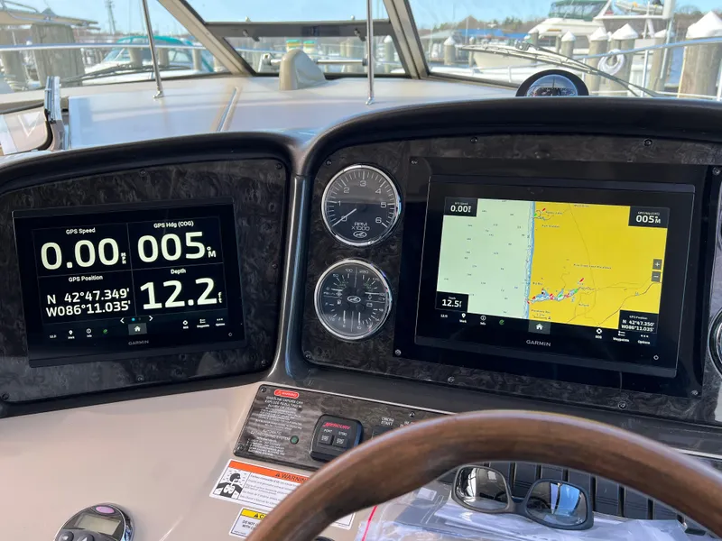 Slide: The Image of Helm dashboard of 2008 Sea Ray 38 Sundancer with navigation screens and gauges. - 7