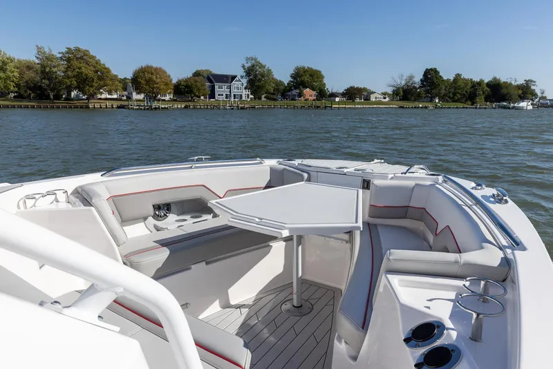Slide: The Image of 2024 Solara 250 CW boat interior with seating and table on a sunny day. - 18