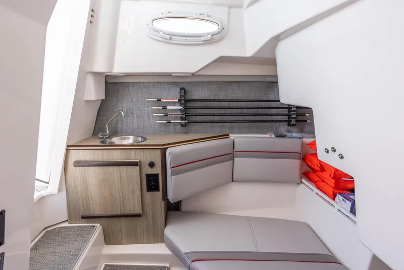Slide: The Image of 2024 Solara 250 CW cabin interior with seating, sink, and storage. - 27