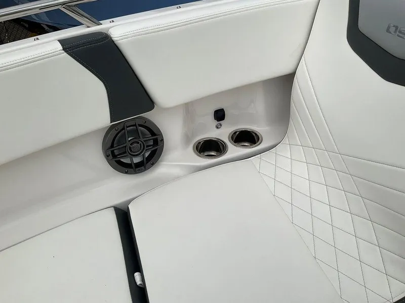 Slide: The Image of 2024 Chaparral 250 OSX boat interior with speaker and cup holders. - 10