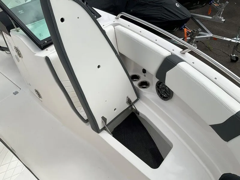 Slide: The Image of 2024 Chaparral 250 OSX boat interior with open storage compartment. - 11