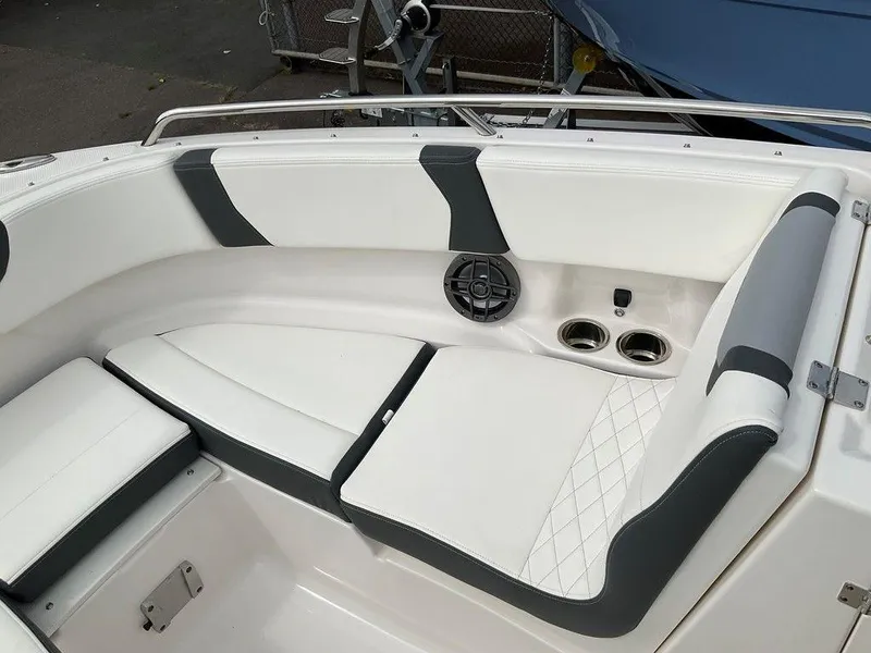 Slide: The Image of 2024 Chaparral 250 OSX boat interior with cushioned seating and cup holders. - 12