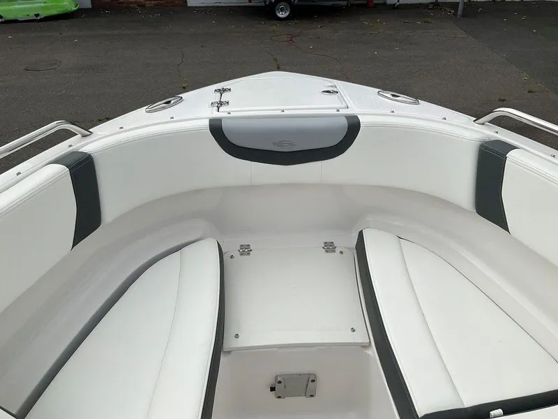 Slide: The Image of 2024 Chaparral 250 OSX boat interior with white seating and sleek design. - 14