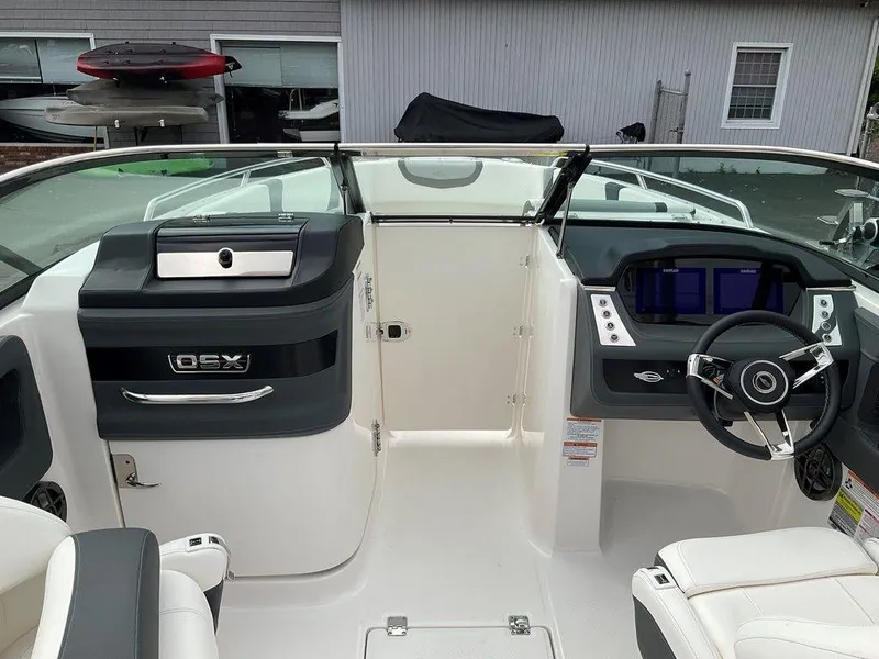 Slide: The Image of 2024 Chaparral 250 OSX boat cockpit with modern dashboard and steering wheel. - 19