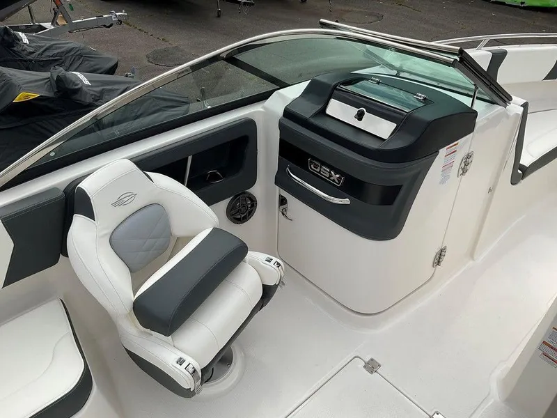 Slide: The Image of 2024 Chaparral 250 OSX boat interior with sleek helm and comfortable seating. - 21